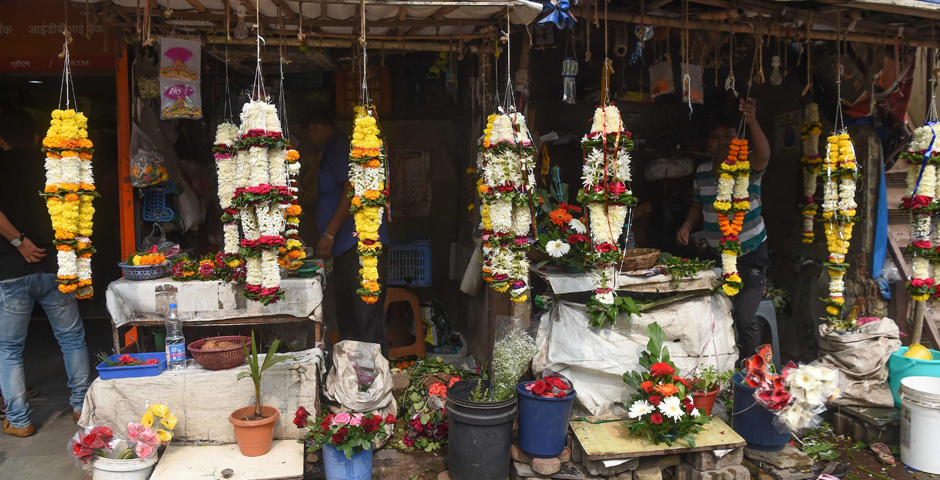 Floral garlands for brides and grooms are displayed for sale next to a marriage hall in Mumbai. - India's weddings are famously lavish -- lasting days and with hundreds if not thousands of guests -- but this season many families are cutting costs even if it risks their social standing. Photo: AFP