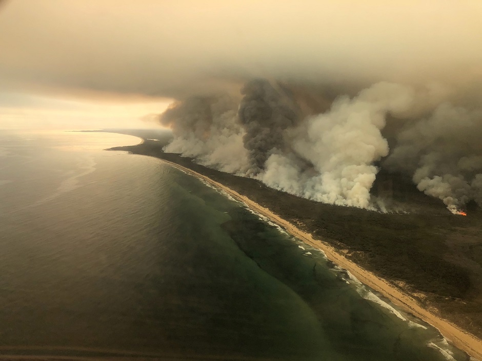 Thick plumes of smoke rise from bushfires at the coast of East Gippsland, Victoria, Australia. PHOTO: Reuters