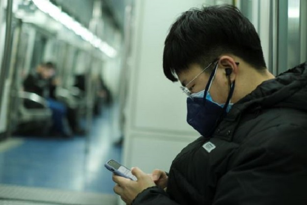 A man wearing two face masks travels in the subway, as the country is hit by an outbreak of the new coronavirus, in Beijing, China January 26, 2020. PHOTO: REUTERS