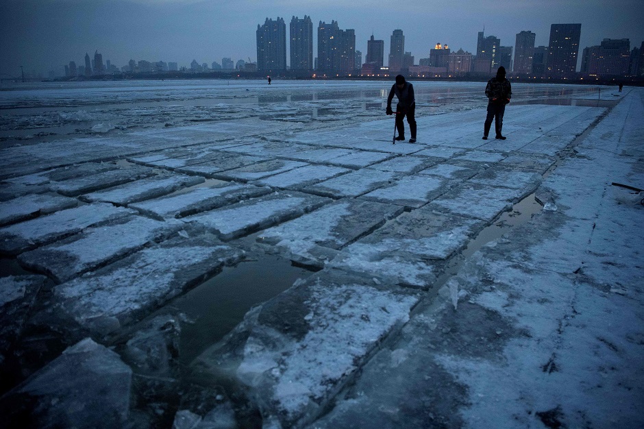 This photo taken on December 11, 2019 shows workers using picks on ice blocks on the frozen Songhua river in Harbin, in China's northeastern Heilongjiang province ahead of the Harbin International Ice and Snow Festival. PHOTO: AFP