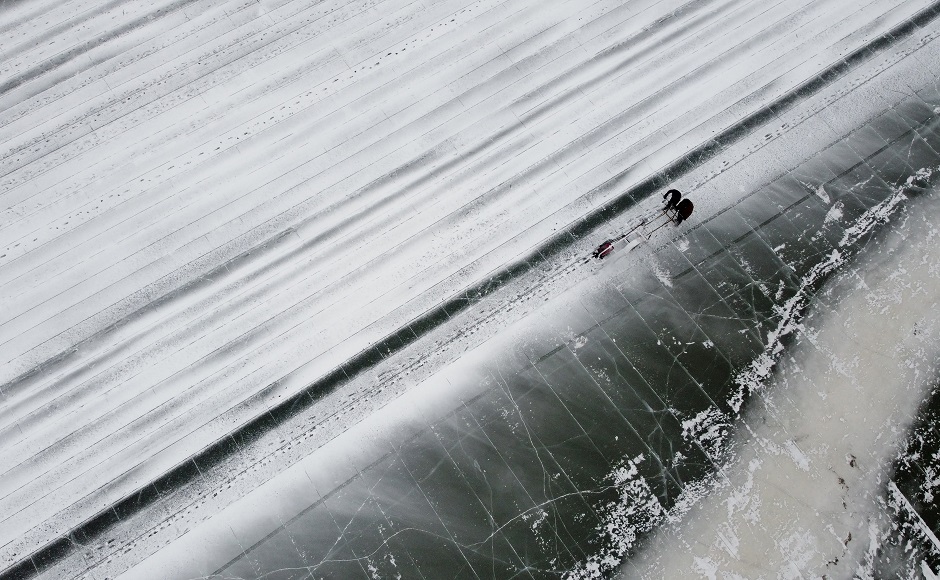 This photo taken on December 10, 2019 shows a worker cutting in the ice to make blocks on the frozen Songhua river in Harbin, in China's northeastern Heilongjiang province ahead of the Harbin International Ice and Snow Festival. PHOTO: AFP
