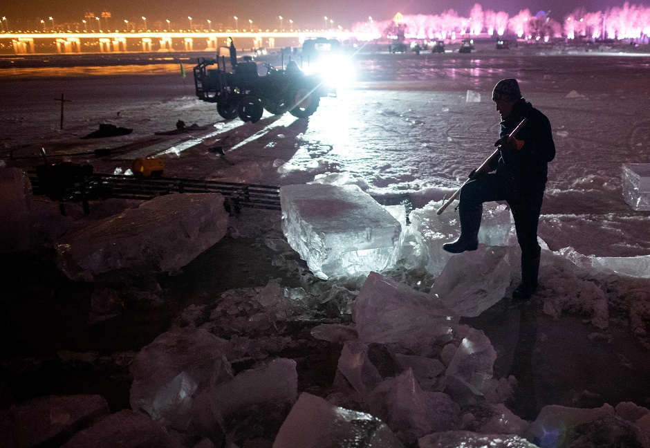 This photo taken on December 10, 2019 shows a worker moving ice blocks on the frozen Songhua river in Harbin, in China's northeastern Heilongjiang province ahead of the Harbin International Ice and Snow Festival. PHOTO: AFP