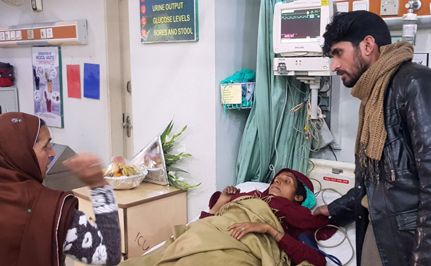 Shahnaz, 40, who was rescued after a heavy snowfall and avalanches in Bakwali village in Neelum Valley near the Line of Control (LoC), receives medical aid at a hospital in Muzaffarabad. PHOTO: REUTERS