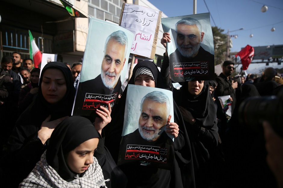 Women hold pictures of Iranian Major-General Qassem Soleimani, head of the elite Quds Force, who was killed in an air strike at Baghdad airport, during a funeral procession and burial at his hometown in Kerman. PHOTO: Reuters