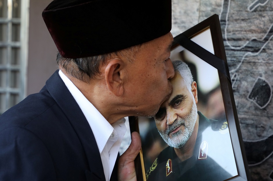 A man kisses a picture of Iranian Major-General Qassem Soleimani, who was killed in a airstrike near Baghdad, outside the Embassy of Iran in Kuala Lumpur. PHOTO: Reuters