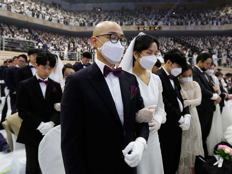 They began in the early 1960s, involving just a few dozen couples at first but with numbers mushrooming over the years. In 1997, 30,000 couples took part in a joint wedding in Washington, and two years later around 21,000 filled the Olympic Stadium in Seoul. Image Credit: AP