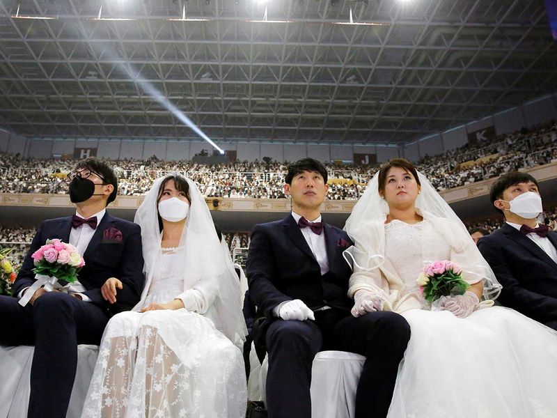 The church founded by Sun Myung Moon - revered as a messiah by his followers - distributed face coverings to the 30,000 crowd, but only some donned them (Photo: Reuters) 