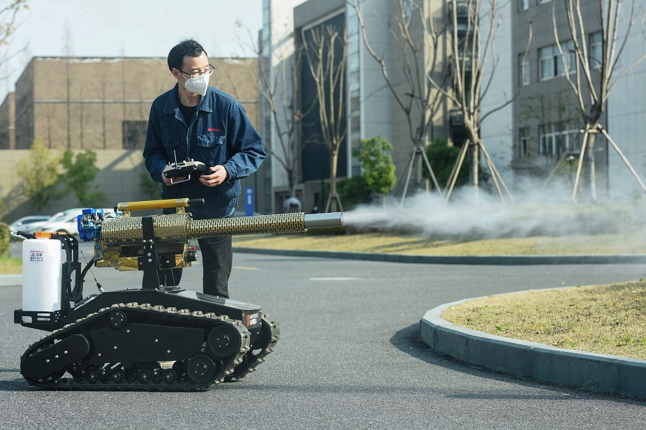  A staff member operates a robot to disinfect streets at the Robot Town in Hangzhou in China's eastern Zhejiang province on February 25, 2020. - China on February 25 reported another 71 deaths from the COVID-19 coronavirus, the lowest daily number of fatalities in over two weeks, which raised the toll to 2,663. PHOTO: AFP