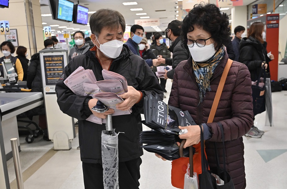 People buy face masks at a retail store in the southeastern city of Daegu on February 25, 2020. - South Korea reported 60 more COVID-19 coronavirus cases on February 25, the smallest increase for four days in the Korea Centers for Disease Control and Prevention's morning updates. The country now has 893 cases. PHOTO: AFP