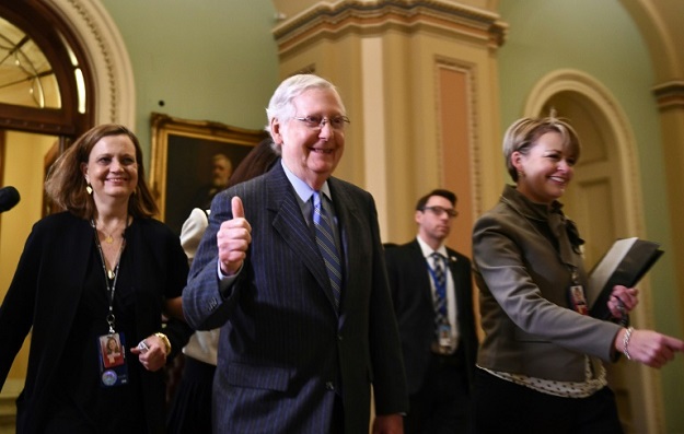 Republican Senate Majority Leader Mitch McConnell gives a thumb's up after the Senate voted not to allow new witnesses at the impeachment trial. PHOTO: AFP