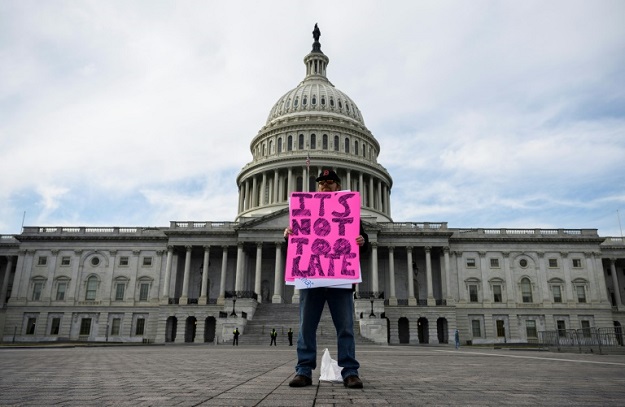A protester stands alone in front of the US Capitol in Washington on February 1, 2020 after the Senate voted not to call witnesses at President Donald Trump's impeachment trial for abuse of power. PHOTO: AFP