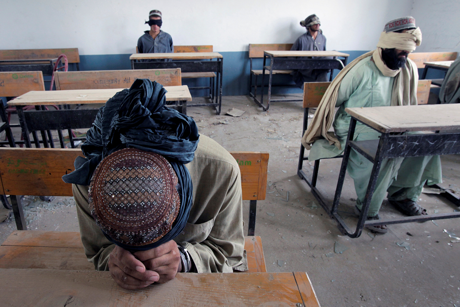 A group of men detained for suspected Taliban activities are held for questioning at a schoolhouse in the village of Kuhak in Arghandab District, north of Kandahar, Afghanistan July 9, 2010. PHOTO: REUTERS