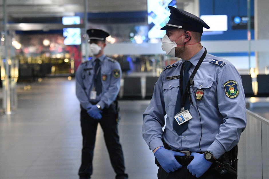 Police officials stand on guard in the hall of Budapest's Liszt Ferenc Airport. PHOTO: AFP