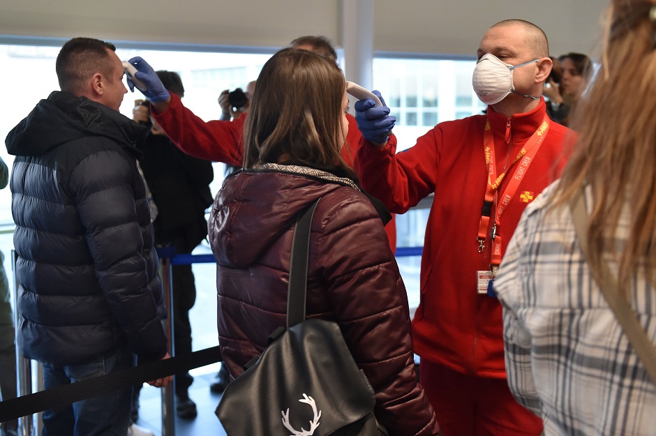 Members of the Airport Medical Service take temperature readings from staff members with a digital thermometer at Budapest's Liszt Ferenc Airport. PHOTO: AFP