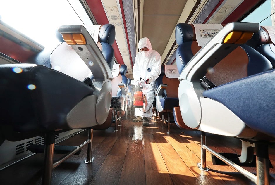 A worker from a disinfection service sprays disinfectant in a bus departing to Daegu as part of preventive measures against the spread of the COVID-19 coronavirus, at a bus terminal in Ansan, south of Seoul. PHOTO: AFP