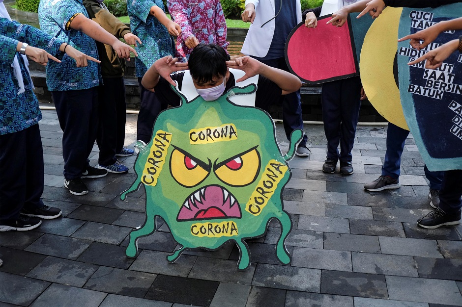 Students show a theatrical performance about coronavirus in Solo, Central Java, Indonesia. PHOTO: Reuters