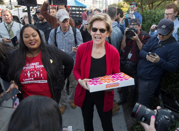 Democratic presidential hopeful Elizabeth Warren, shown here passing out treats to protesting workers in Las Vegas, was under pressure to deliver a command performance in the Democratic debate on February 19, 2020. PHOTO: AFP