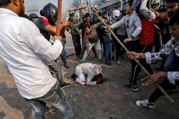 A group of men chanting pro-Hindu slogans, beat Mohammad Zubair, 37, who is Muslim, during protests sparked by a new citizenship law in New Delhi, India, February 24, 2020. PHOTO: REUTERS