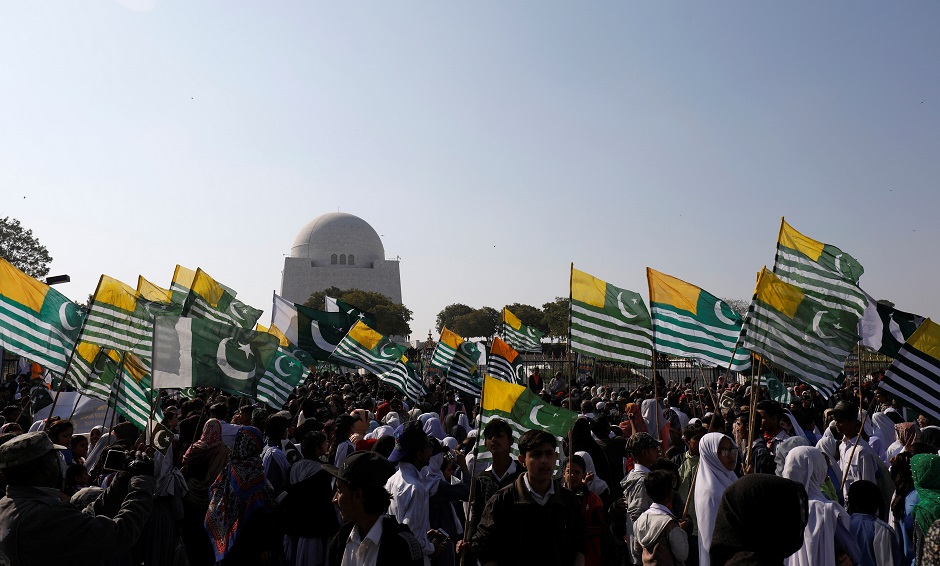 Students and others carry Azad Kashmir and national flags as they gather to mark Kashmir Solidarity Day. PHOTO: Reuters