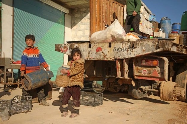 Syrians load their belongings onto a truck as they prepare to flee the village of Kafr Nuran in the northern province of Aleppo.PHOTO: AFP