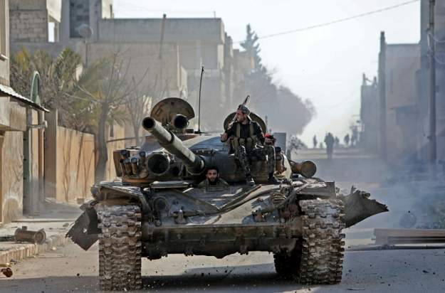 A rebel tank patrols the streets of Saraqeb, reduced to a ghost town abandoned by its residents after weeks of fighting. PHOTO: AFP