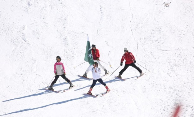 Pakistani women skiers led by Khushim Sahiba performing Formation Display during the prize distribution ceremony of International ski championships at Malam Jabba. PHOTO: APP
