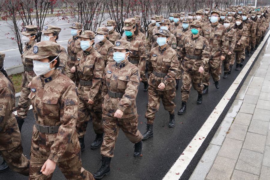 Members of a military medical team head for Wuhan Jinyintan Hospital in Wuhan. PHOTO: XINHUA