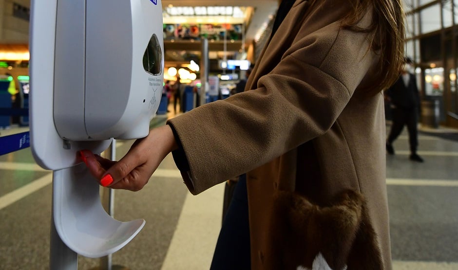 A woman uses hand sanitizer at Los Angeles International Airport on March 12, 2020 one day before a US flight travel ban hits 26 European countries amid ongoing precautions over the Coronavirus. PHOTO: AFP