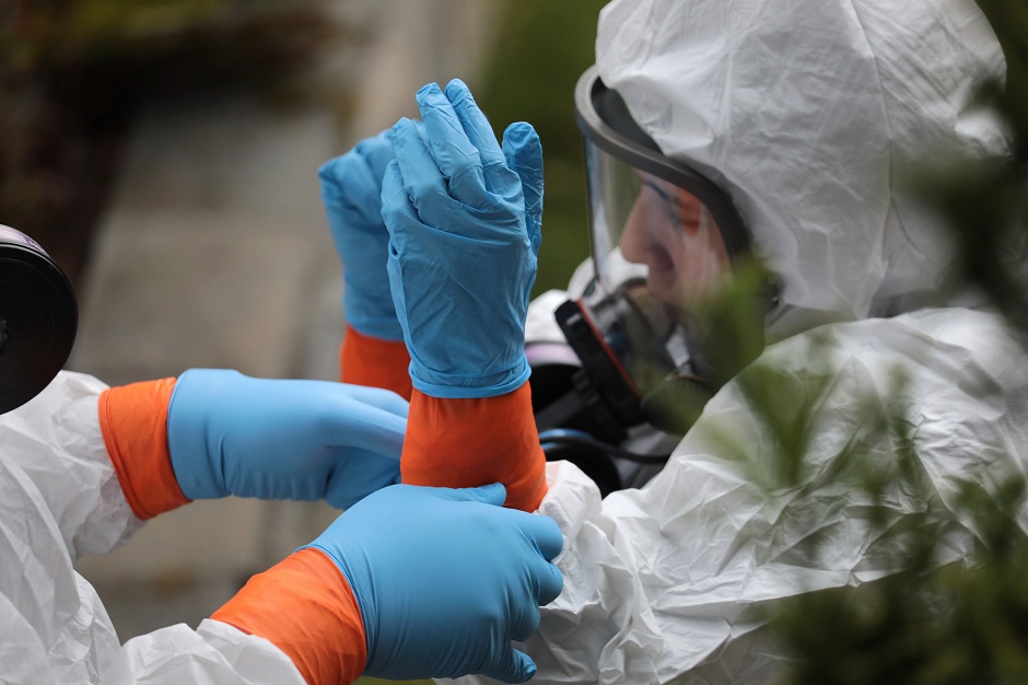 A cleaning crew wearing protective clothing (PPE) to protect them from coronavirus prepares to enter the Life Care Center on March 12, 2020 in Kirkland, Washington. The nursing home in the Seattle suburbs has had the most deaths due to COVID-19 of anywhere in the United States. PHOTO: AFP