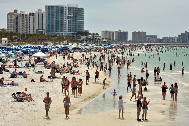 People crowd the beach, while other jurisdictions had already closed theirs in efforts to combat the spread of coronavirus in Clearwater, Florida. PHOTO: Reuters