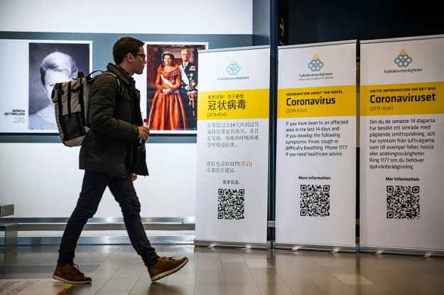 A passenger arriving in Stockholm's Arlanda airport is greeted by signs produced by the public health agency advising travelers what to do if they show symptoms of infection. PHOTO: AFP.