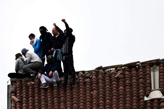 Italian officials faced a further headache after prisoners fearful of infection protested or rioted in 23 jails across the country -- leaving several dead. PHOTO: AFP