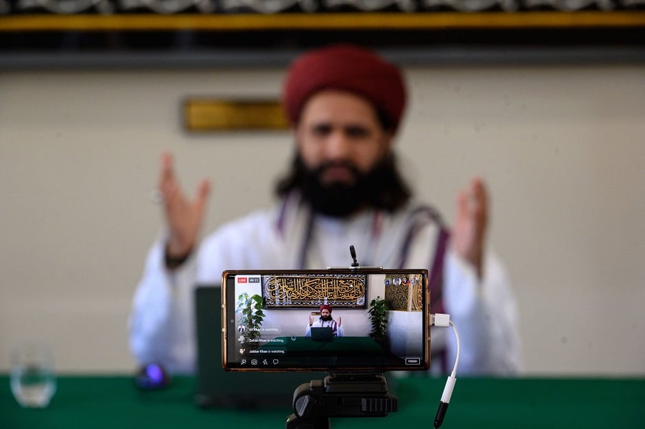 Imam Hassanat Ahmed delivers his Friday broadcast entitled 'Preparing for a Unique Ramadan' via multiple social media platforms from the otherwise empty Noor Ul Islam Mosque on April 24, in Bury, Greater Manchester, United Kingdom. PHOTO: AFP