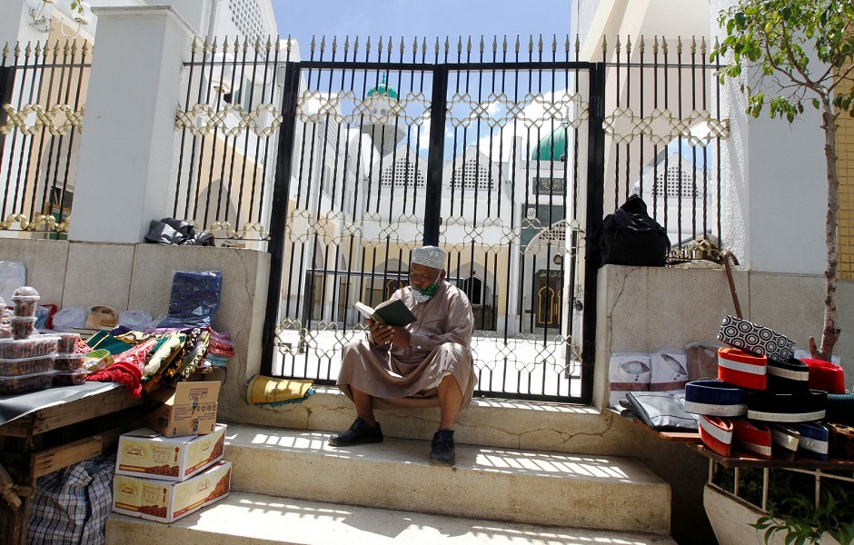 A Muslim faithful reads the Koran outside the closed Jamia Mosque in Nairobi, Kenya, on April 24. PHOTO: Reuters