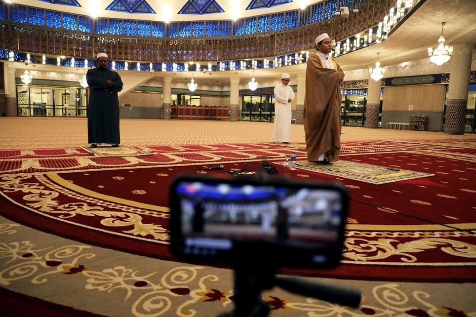A Muslim Imam leads a prayer in an empty National Mosque, broadcast live on April 24 in Kuala Lumpur, Malaysia. PHOTO: REUTERS