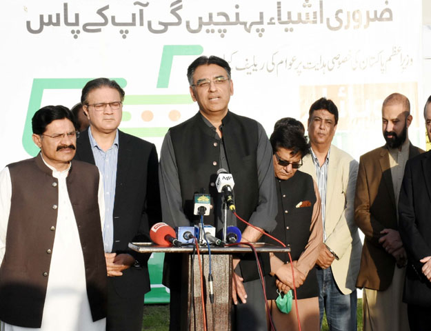 Federal Planning and Development Minister Asad Umar speaks to the media after inaugurating mobile utility stores in Islamabad. PHOTO: EXPRESS.