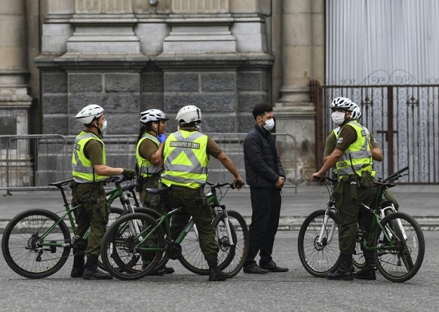 Chilean soldiers patrol in Santiago, Chile, before more than 1.3 million people in the city enter into total quarantine for a week. PHOTO: AFP 