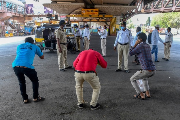 Mumbai police order people to do sit-ups as punishment for going out without a valid reason during a government-imposed nationwide lockdown in India. PHOTO: AFP 