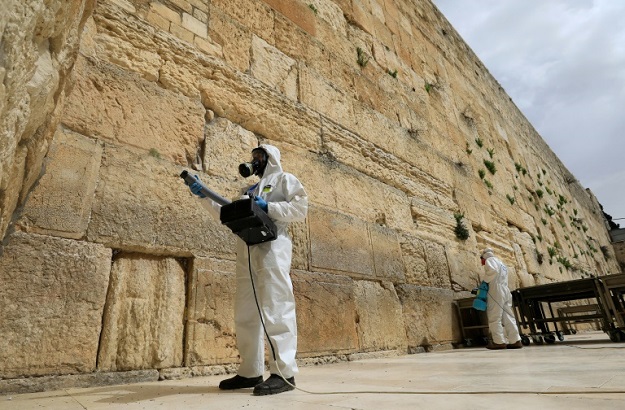 Workers sanitise the Western Wall, the most holy site where Jews can pray against the spread of the coronavirus COVID-19 in Jerusalem. PHOTO: AFP