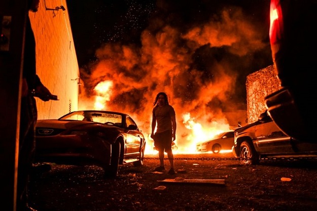 Cars were set on fire in Minneapolis during demonstrations against the death in police custody of unarmed African American George Floyd. PHOTO: AFP