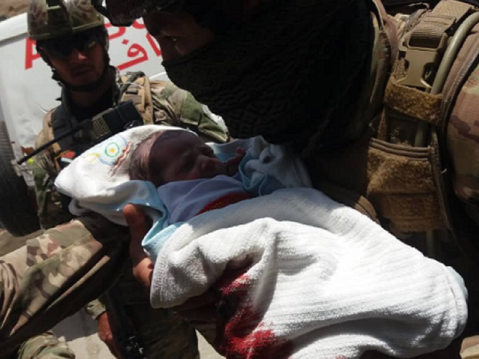 Security forces rescuing a newborn baby from hospital under attack in Kabul.PHOTO: TOLO NEWS
