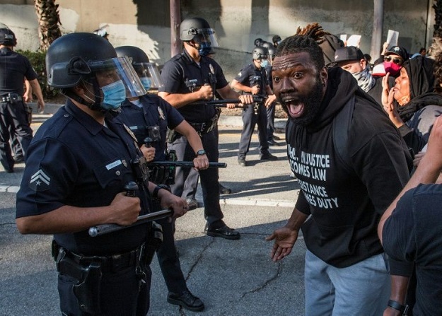 A demonstrator confronts police in Los Angeles as he protests the death of George Floyd in police custody in Minneapolis. PHOTO: AFP 