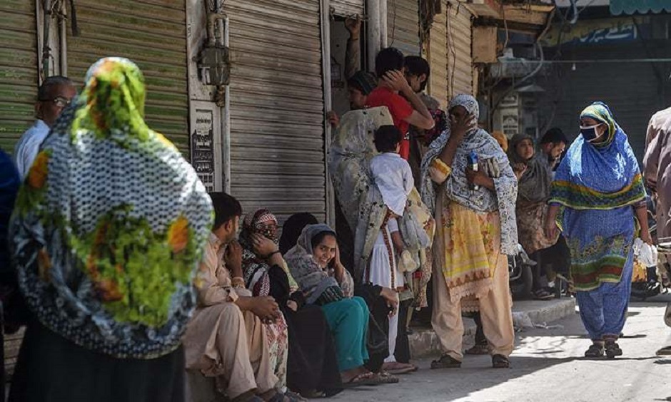 People gather as they wait for the reopening of shops in Lahore on Saturday. AFP