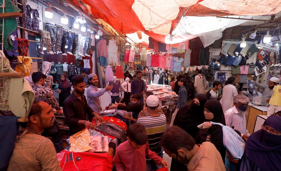 People shop from stalls in a market. PHOTO: REUTERS