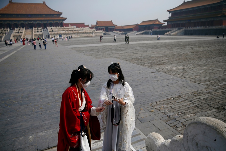 Visitors wearing face masks and dressed in Hanfu, or Han clothing, are seen at the Forbidden City as it reopens on the first day of the five-day Labour Day holiday following the coronavirus disease (COVID-19) outbreak, in Beijing, China May 1, 2020. REUTERS/Tingshu Wang