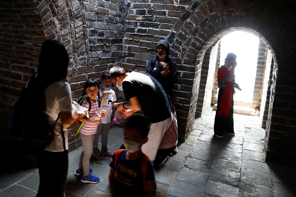 Tourists walk inside a watchtower while visiting the Mutianyu section of the Great Wall of China on the first day of the five-day Labour Day holiday following the coronavirus disease (COVID-19) outbreak, on the outskirts of Beijing, China May 1, 2020. REUTERS/Thomas Peter