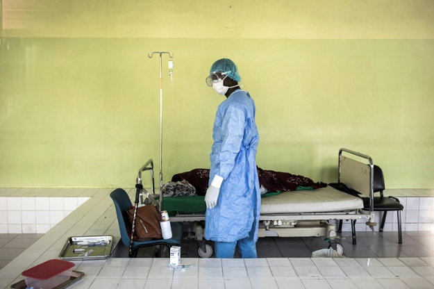 A health worker tends to a patient inside a COVID-19 ward in Pikine Hospital in Dakar, Senegal. PHOTO: AFP