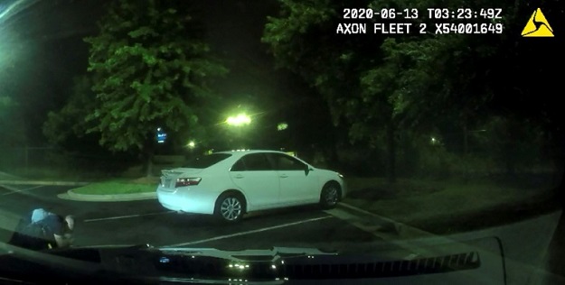 This undated handout photo obtained June 14, 2020, from the Atlanta (Georgia) Police Department shows an image from a video camera of a struggle a day earlier between police officers and suspect Rayshard Brooks (L). PHOTO: AFP 