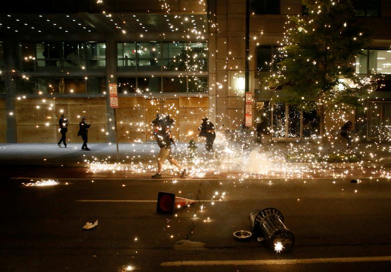 People run as police disperse demonstrators during a protest amid nationwide unrest following the death in Minneapolis police custody of George Floyd, in Washington. Photo: Reuters