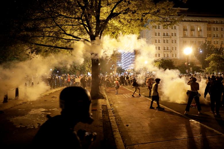 Security forces fire tear gas to demonstrators during a protest against the death in Minneapolis police custody of George Floyd, in Washington, U.S., May 30, 2020. REUTERS